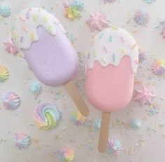 two ice cream pops with sprinkles on them