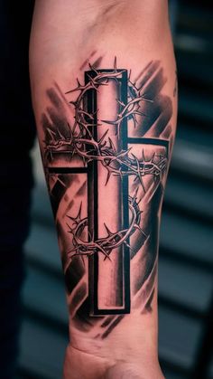 a tattoo with a cross and crown of thorns on the side of his arm