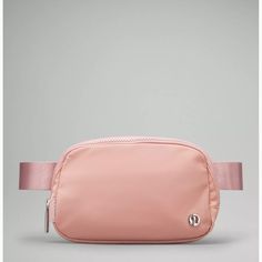 a pink fanny bag sitting on top of a table