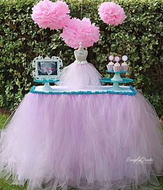 the tulle table skirt diy is on display in front of some bushes and trees