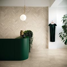 a room with a green counter and potted plants on the wall next to it