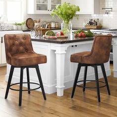 two brown leather stools sit at the center of a kitchen island