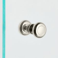 a close up of a light switch with two knobs on each side and a white background