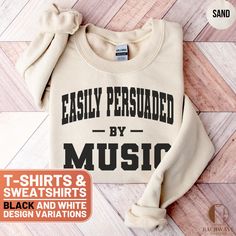 Celebrate your love for music with this humorous and stylish T-Shirt and Sweatshirt featuring the "Easily Persuaded by Music" design. Perfect for music lovers, musicians, and those who can't resist a good tune, this fun and quirky top makes a great gift for birthdays, holidays, or just because. Ideal for casual wear, concerts, or music festivals, you'll love showing off your musical passion with this comfortable and eye-catching apparel. Available in various sizes for both men and women, this versatile piece is a must-have addition to any music enthusiast's wardrobe. ❤️ HOW TO ORDER ❤️   1. Check out all the photos for sizing and color options.📏 2. Choose your perfect size and color from the drop-down menus!✨  3. Click "ADD TO CART" and feel free to add as many as you wish! 🛒  4. Hit "PR Cheap Music-themed Shirt With Letter Print, Music-themed Slogan Crew Neck Top, Music-themed Slogan Tops With Crew Neck, Music-themed Slogan Top With Crew Neck, Music-themed Cotton Tops With Slogan, Music-themed Cotton Slogan Tops, Music-themed Band Logo Tops With Relaxed Fit, Fall Music-themed Cotton Tops, Relaxed Fit Music-themed Tops With Band Logo