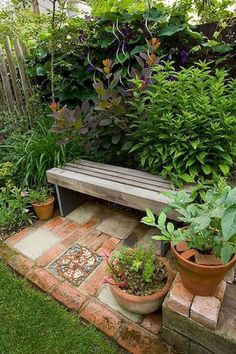 a wooden bench sitting in the middle of a garden