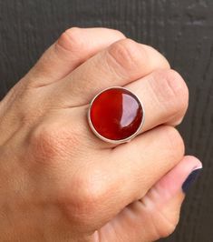 A stunning blood red and orange hued carnelian has been set in sterling silver with a handmade ring band from sterling silver half dome wire. This red carnelian has different hues throughout with varying colors of brighter red to darker red. The stone is 18mm in size. Made to order! Carnelian is a stabilizing stone and helps clear negative energy as well as stimulate creativity! Boho Rocker, July Birthstone Ring, Orange Carnelian, Red Carnelian, Carnelian Ring, Blood Red, July Birthstone, Half Dome, Ring Band