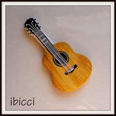 a small wooden ukulele sitting on top of a white table