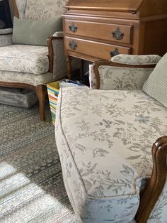 a living room filled with furniture next to a dresser and chair on top of carpeted floor