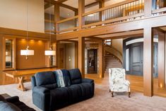 a living room filled with furniture next to a staircase