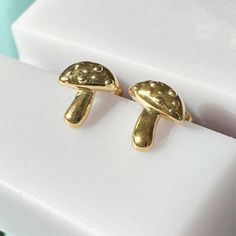 Holy magical mushrooms! These tiny bite sized mushroom studs are the perfect stacking stud to wear alongside your second and third piercings (but don't get us wrong, they also love solitude). Measures 7mm x 6.25 mm. Our materials make for an amazing, high quality, seamless, jewelry piece with longevity. Our earrings are plated with 18k gold, 18k rose gold, or rhodium and finished with a protective coating. A little secret we’ll keep between us: it looks way more than it costs.