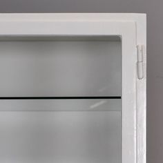 a white refrigerator freezer sitting on top of a kitchen counter next to a wall