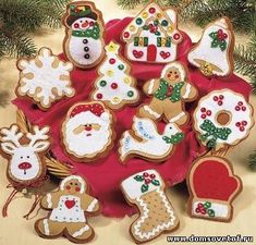 an assortment of decorated christmas cookies on a red plate