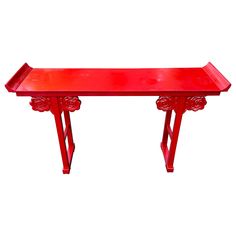 a red bench sitting on top of a white floor