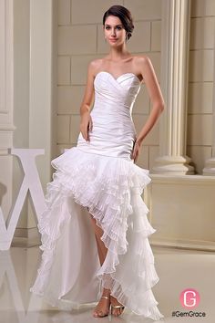 a woman in a white wedding dress posing for the camera