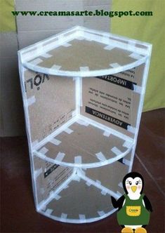 a penguin is standing in front of a cardboard box with the bottom section cut out