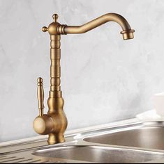 a kitchen faucet that is gold in color