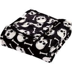 a black and white blanket with skulls on it