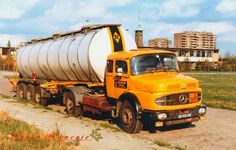 an old yellow truck is parked on the side of the road