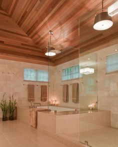 a bath room with a tub a sink and candles