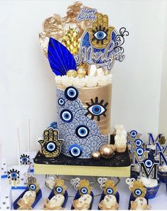 a table topped with lots of blue and gold items on top of a white table