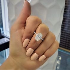 a woman's hand with a ring on it and a diamond in the middle