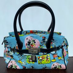 This Disney Minnie & Mickey Mouse Lock & Key Satchel Purse Handbag Is A Must-Have For Any Disney Fan. The Blue Color Adds A Pop Of Fun To Any Outfit, While The Medium Size Makes It Perfect For Everyday Use. The Satchel Features A Classic Design With Mickey Mouse And Minnie Mouse, Making It A Great Addition To Any Disneyana Collection. The Handbag Is Made By Disney, Ensuring Its Quality And Authenticity. It Is Perfect For Those Who Love Contemporary Designs With A Touch Of Disney Magic. This Satc Disney Blue Shoulder Bag For Travel, Blue Rectangular Bag For Disney Trips, Mickey Mouse And Minnie Mouse, Disney Handbags, Disney Bag, Disney Fan, Satchel Purse, Disney Magic, Purses And Handbags