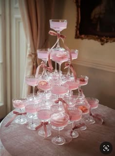 a very pretty pink cake with lots of glasses on it