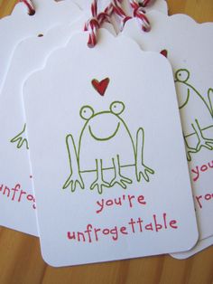 four tags with the words you're unfrgettable on them hanging from a wooden table