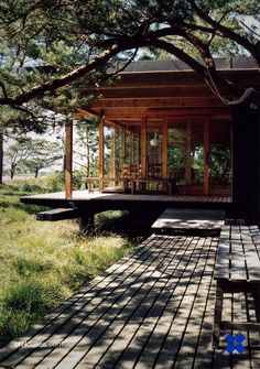 a wooden bench sitting on top of a lush green field