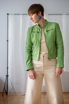 Buy 3 items and get 30% off your entire order. Limited offer. All orders are shipped via FedEx. Shipping to the US typically takes 2 to 3 business days, while within the EU, it takes 2 to 6 business days. Vintage genuine leather jacket in extraordinary apple green colour. Crafted from soft leather, this zip-up spring number features cropped length and stand-up collar with snap button closure at neck. It is elevated with zipper pockets at chest and on the side. An absolutely cool and fun piece fo Casual Green Fitted Leather Jacket, Green Long Sleeve Leather Jacket Casual Style, Casual Green Long Sleeve Leather Jacket, Spring Leather Jacket With Pockets For Everyday, Green Leather Jacket For Spring Workwear, Casual Green Leather Jacket For Work, Trendy Green Everyday Outerwear, Trendy Green Leather Jacket For Work, Green Casual Biker Jacket With Zipper Closure