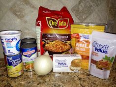 some food is sitting on top of a counter next to an onion, cheese and other items