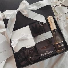 an open gift box containing two bottles of champagne