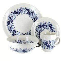 a blue and white dinnerware set on a white background