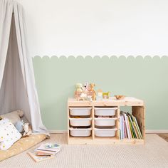 a child's playroom with toys and storage containers in front of the wall