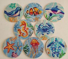 six hand painted buttons with sea animals on them