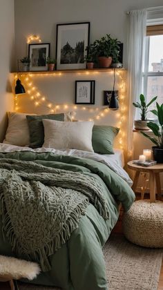 a bed with green blankets and lights on the headboard in a room filled with potted plants