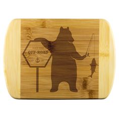 a wooden cutting board with an image of a bear holding a fishing rod