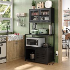 a kitchen with green walls and wooden floors