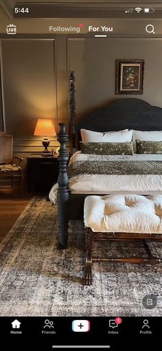 a large bed sitting on top of a wooden floor next to a table with two lamps