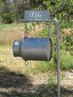 a metal bucket hanging from a pole with a sign on it that says, 1917