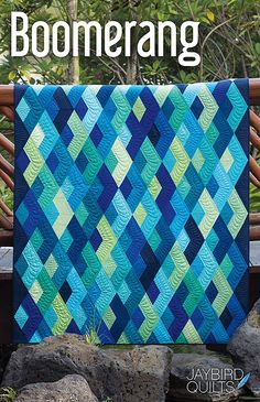 the book cover shows a blue and green quilt on a bench with trees in the background