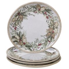 four plates with holly wreath designs on them