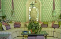 a living room filled with lots of furniture next to a tall clock mounted on the wall