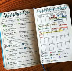 an open planner book sitting on top of a wooden table