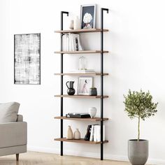 a living room with a couch, chair and book shelf on the wall in front of it