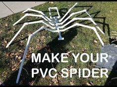 a white spider sculpture sitting on top of green grass