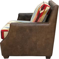 a brown leather chair with colorful pillows on the armrests and back rest area