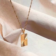 SUNBEAM PENDANT ∙ GOLD NECKLACE ∙ RECTANGLE PENDANT Add a touch of glamor to your look with our exquisite rectangle sunburst pendant necklace in 18k gold! Handcrafted to perfection, this stunning bohemian necklace features a waterproof geometric design that is both stylish and durable. The rectangular pendant is intricately adorned with a sunburst pattern, made with the finest materials to ensure lasting quality. Whether you're hitting the town or just adding a touch of sparkle to your everyday style, this necklace is the perfect finishing touch. ▸ 18K Gold Plated ▸ 316L Stainless Steel ▸ Adjustable Length ▸ Tarnish-Free - Hypoallergenic and safe for sensitive skins This piece is a luxurious and eye-catching necklace. Elegant and prestigious, wear it with pride ✨ Buy 2 or more items and sa Trendy Gold Rectangular Necklaces, Trendy Gold Rectangular Necklace, Trendy Gold Rectangular Pendant Jewelry, Trendy Square Gold Jewelry, Trendy Gold Rectangular Pendant Necklace, Rectangular Gold Plated Necklace, Square Gold Necklace For Everyday, Everyday Square Gold Necklace, Gold Boho Necklace