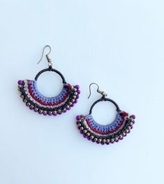 Woven colors with beads. Handcrafted. Unique Purple Earrings With Dangling Beads, Bohemian Earrings With Large Round Beads, Handmade Artisan Purple Earrings, Purple Artisan Earrings With Dangling Beads, Artisan Purple Earrings With Dangling Beads, Bohemian Purple Chandelier Earrings With Ear Wire, Artisan Purple Jewelry With Colorful Beads, Purple Large Beads Jewelry For Festival, Bohemian Large Bead Hoop Earrings Gift