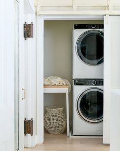 a washer and dryer in a small room next to each other on the floor